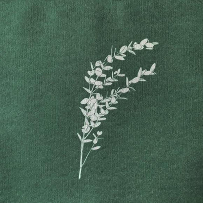 Eclectic Françoise Paviot eucalyptus dinner napkin in deep green airlaid material with white botanical branch print.