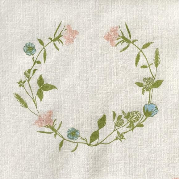 Eclectic Françoise Paviot dinner napkin featuring a delicate pastel wildflower wreath on linen-like airlaid material