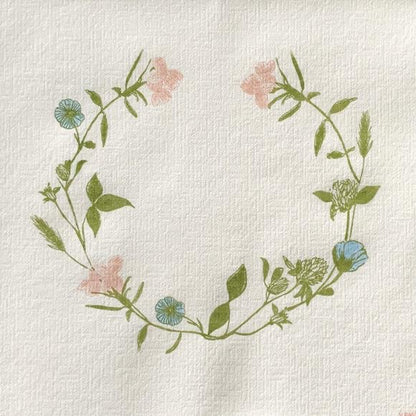 Eclectic Françoise Paviot dinner napkin featuring a delicate pastel wildflower wreath on linen-like airlaid material
