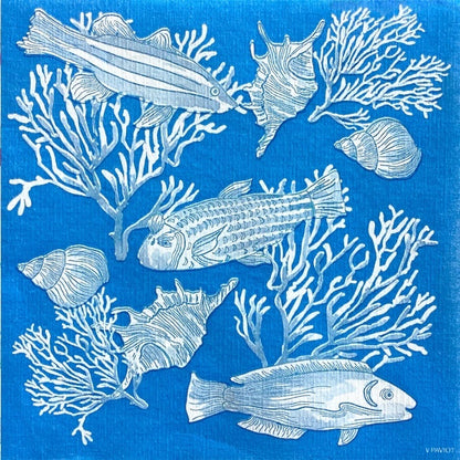 Eclectic Françoise Paviot Fonds Marin blue airlaid dinner napkin with white fish, coral, and seashell marine motifs.