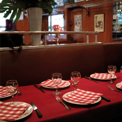Eclectic Françoise Paviot Bistrot Rouge red and white gingham dinner napkins set on a restaurant table