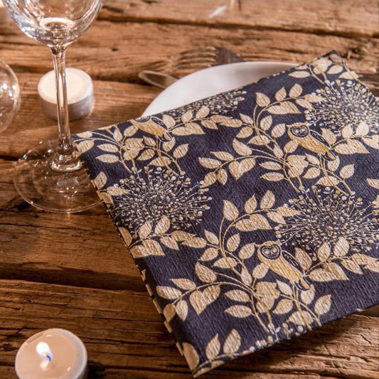 Eclectic Françoise Paviot Hibou Nuit dinner napkin with gold owl and branch pattern on midnight blue airlaid fabric