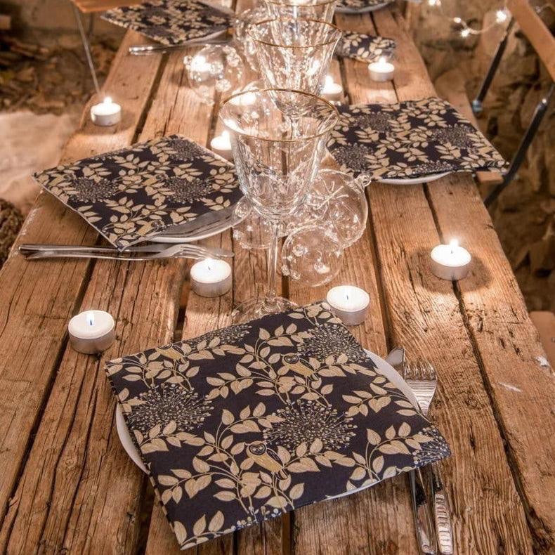 Eclectic Françoise Paviot Hibou Nuit dinner napkins with gold owl and branch print on midnight blue airlaid material.