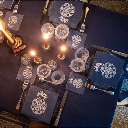 Eclectic Françoise Paviot Éclat du Soir midnight blue and silver airlaid dinner napkins on a formal table setting.