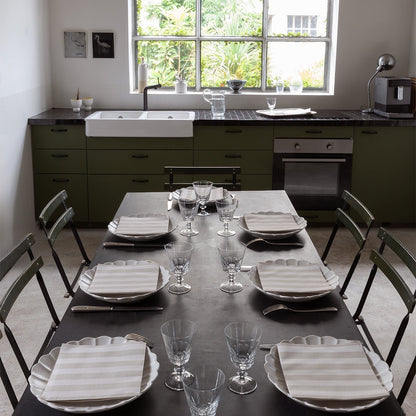 Eclectic Françoise Paviot Rayure Mocha striped airlaid dinner napkins set on a modern dining table in a kitchen