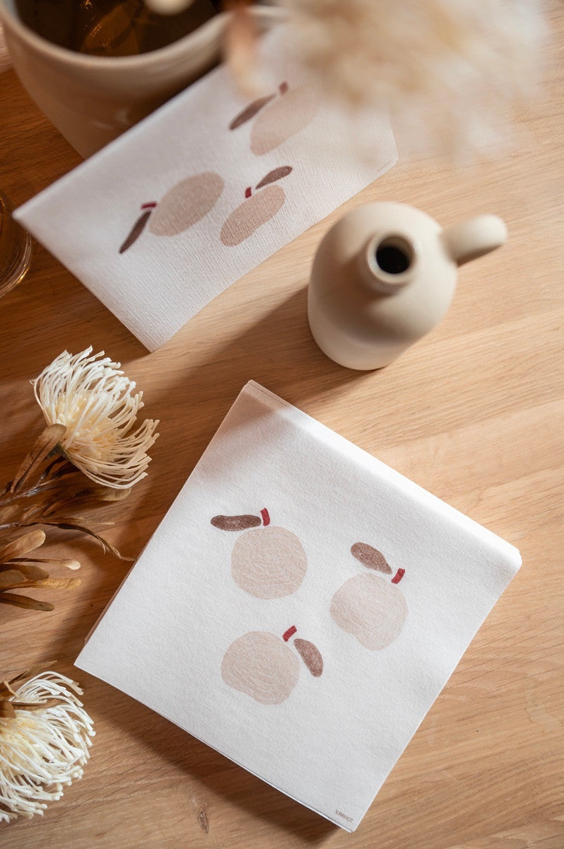 Eclectic Françoise Paviot Pomme airlaid dinner napkins with a minimalist apple motif on a wooden table setting