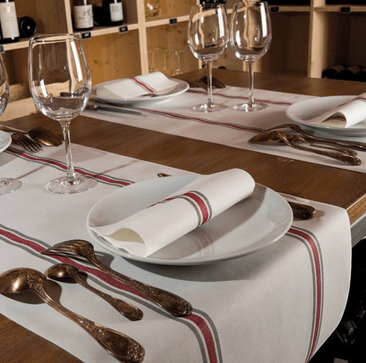 Eclectic Françoise Paviot Torchon Rouge airlaid dinner napkins with red and grey stripes on a rustic wooden table