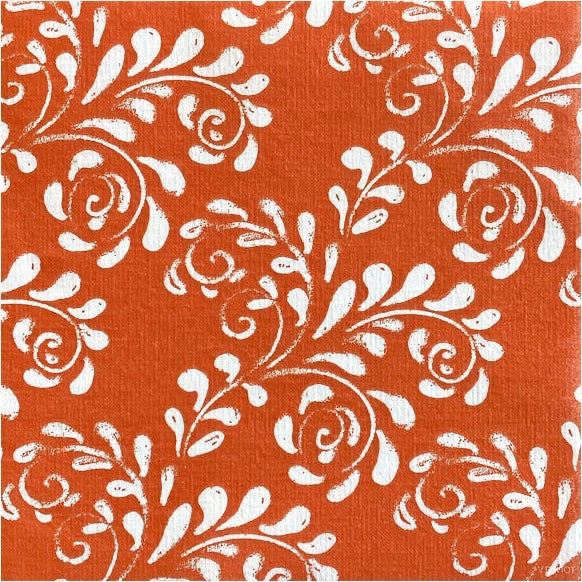 Eclectic Françoise Paviot Arabesque Terra dinner napkin featuring a white floral pattern on a terracotta background.