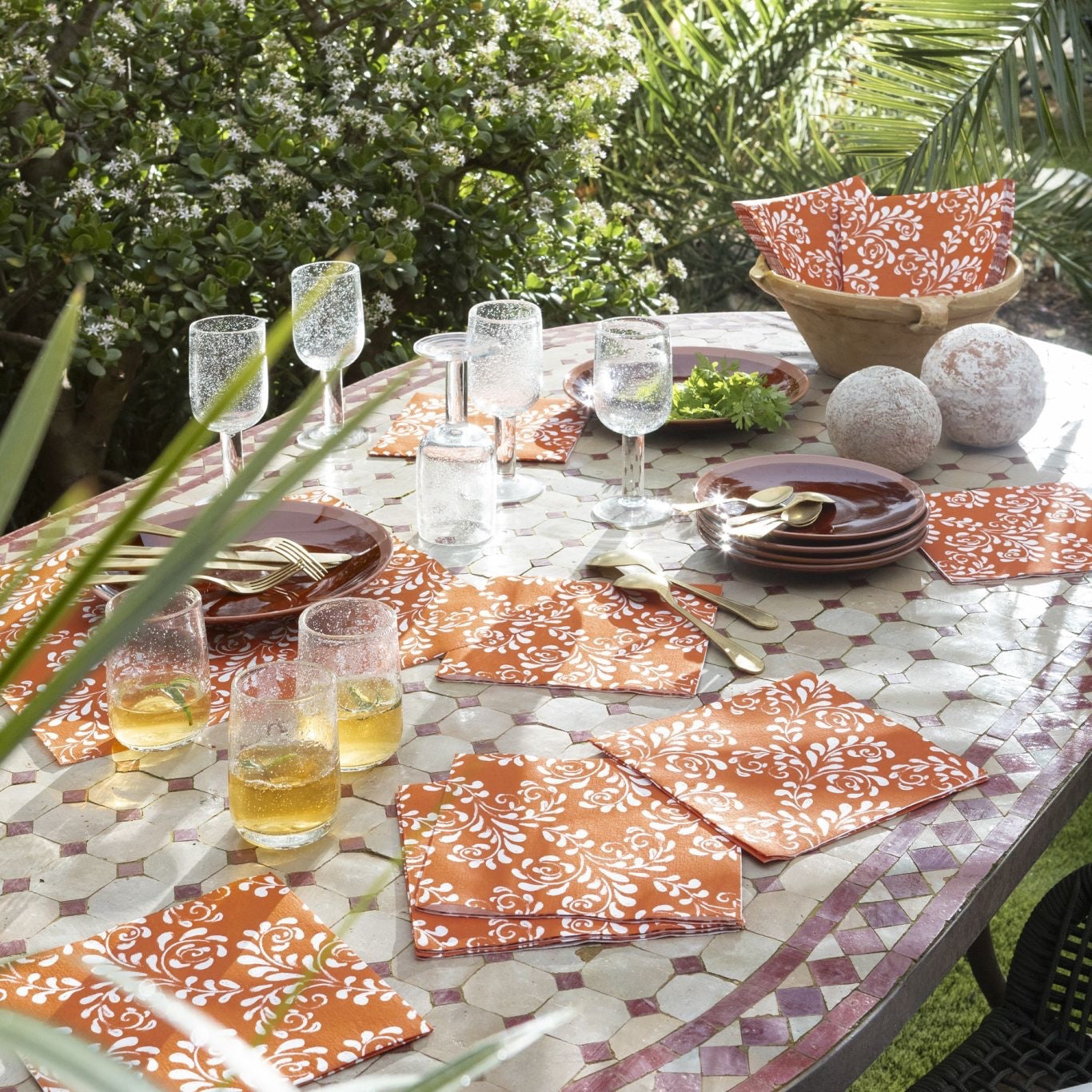 Eclectic Françoise Paviot Arabesque Terra dinner napkins with white floral patterns on a terracotta airlaid fabric.