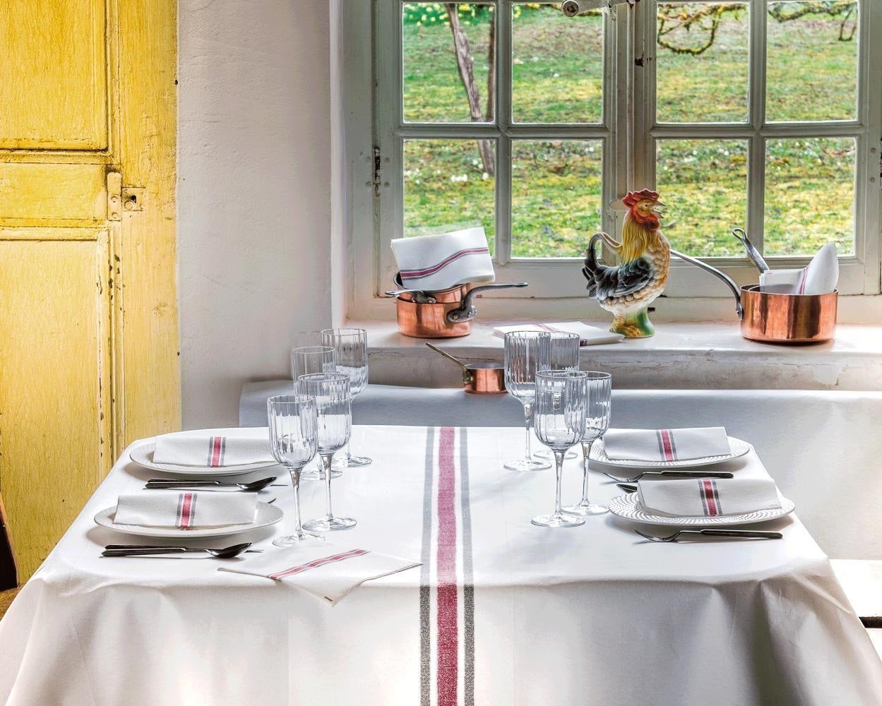 Eclectic Françoise Paviot Torchon Rouge napkins with red and grey stripes on a rustic dining table setting