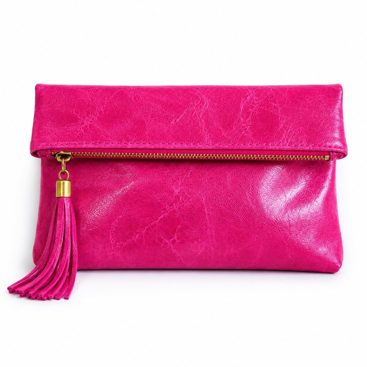 Eclectic fuchsia leather foldover clutch with a decorative tassel and zip closure on a white background.