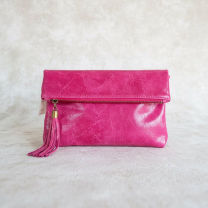 Eclectic fuchsia Italian leather foldover clutch with a decorative tassel and silver-tone hardware.