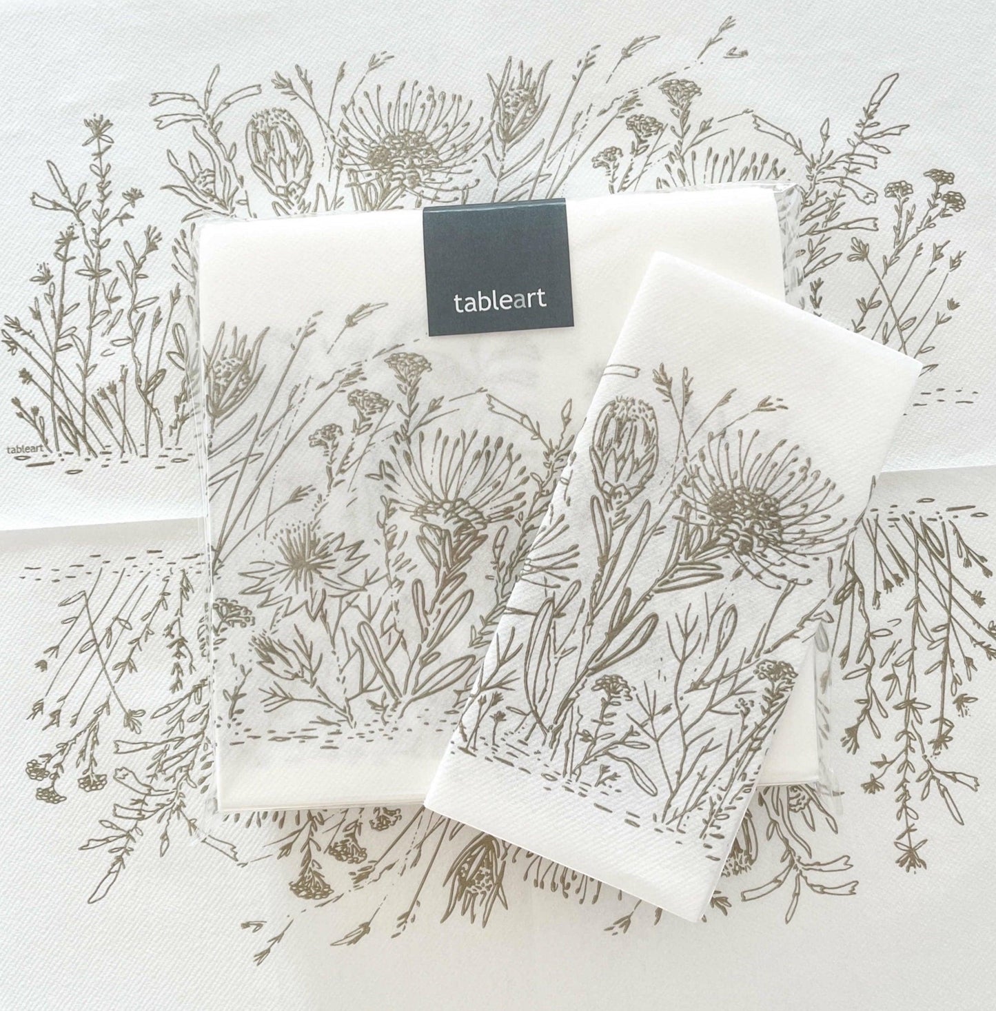 Eclectic Fynbos oatmeal botanical print airlaid napkins with a linen-like texture on a white background.