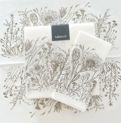 Eclectic Fynbos oatmeal botanical print airlaid napkins with a linen-like texture on a white background.