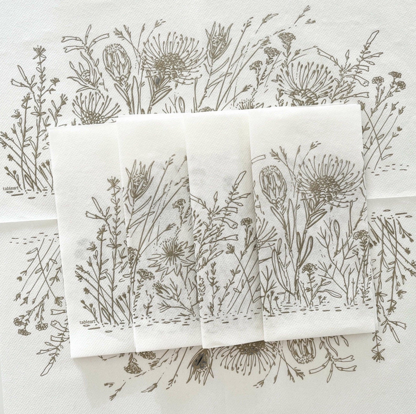 Eclectic Fynbos oatmeal botanical print airlaid napkins with a linen-like texture on a white background.