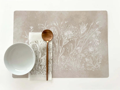 Eclectic Fynbos Oatmeal reusable placemat with white botanical line art, satin finish, and wipe-clean paperboard.