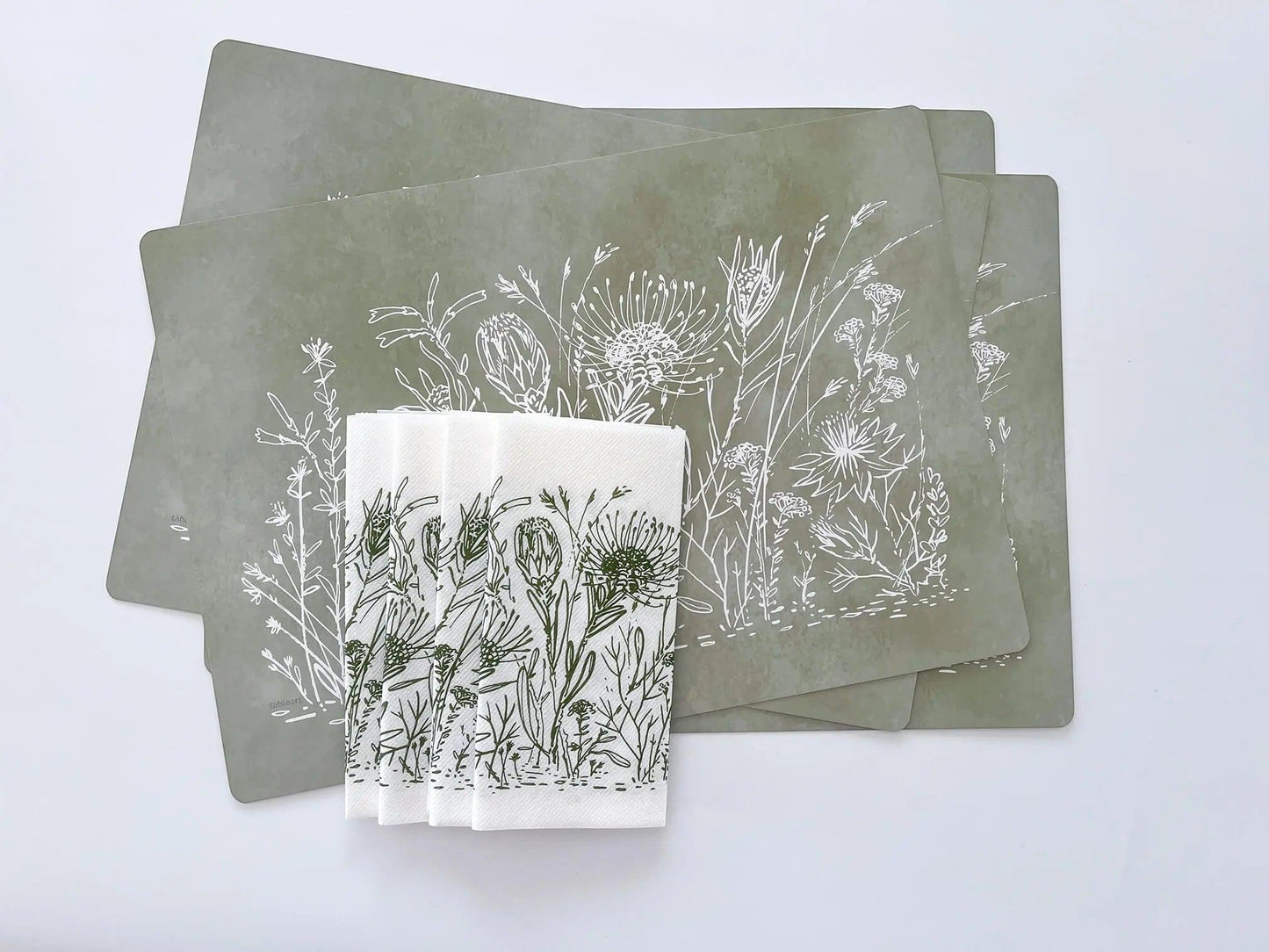 Eclectic Fynbos sage green reusable paperboard placemats with white botanical illustrations in a set of four.