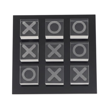 Eclectic glass noughts and crosses game with clear glass pieces on a sleek black square base for modern home decor.