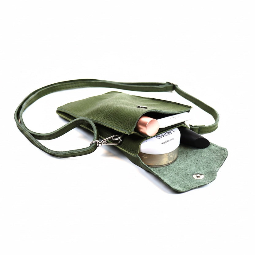 Eclectic green pebbled leather phone crossbody bag with magnetic closure and adjustable strap holding small essentials