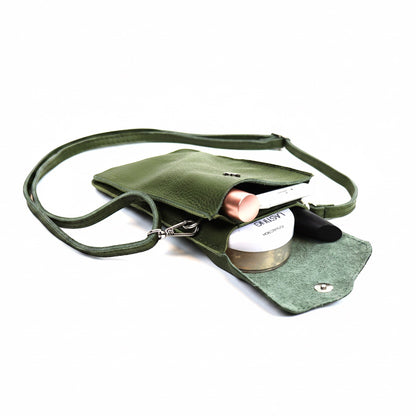 Eclectic green pebbled leather phone crossbody bag with magnetic closure and adjustable strap holding small essentials