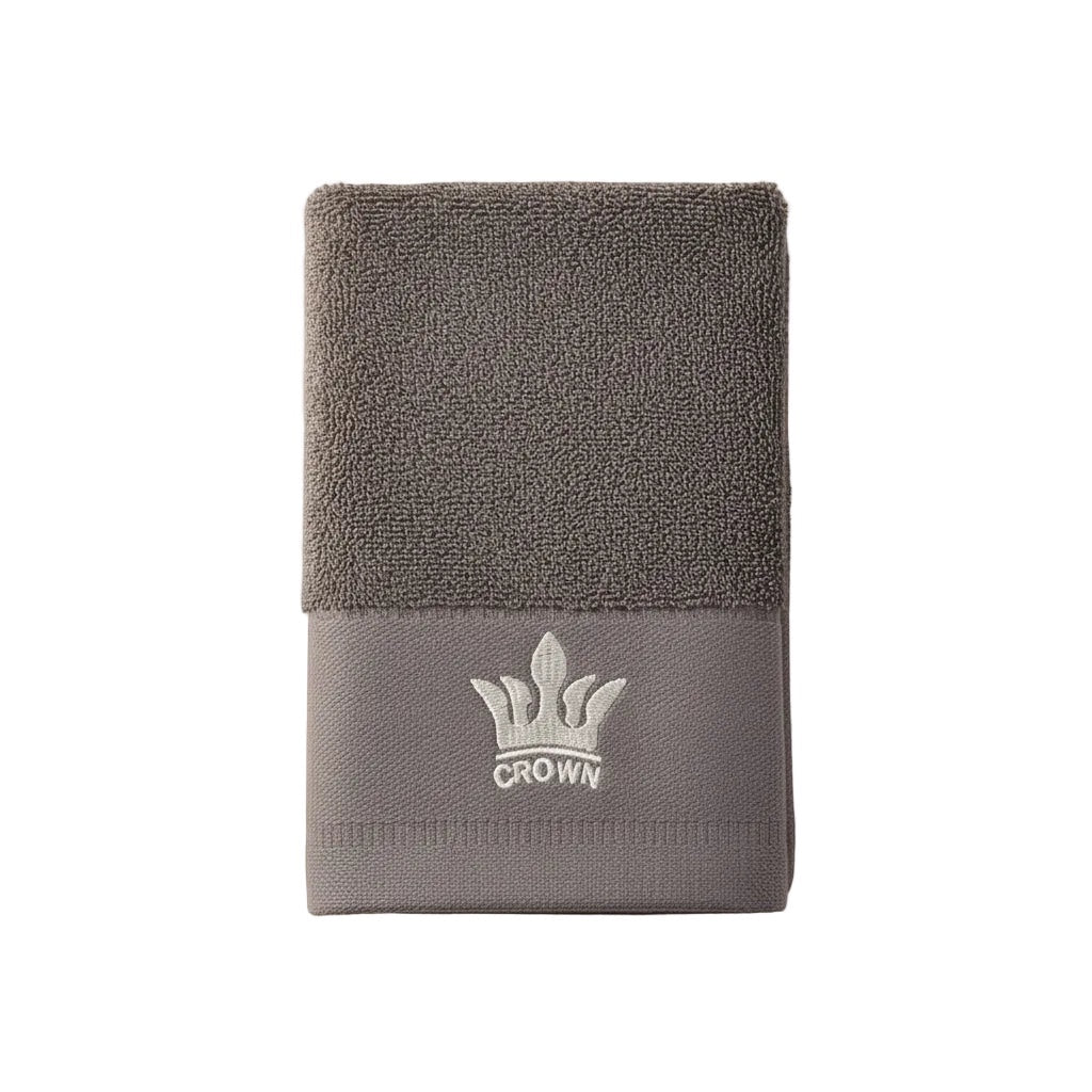Eclectic grey cotton guest towel featuring an elegant embroidered crown detail and soft absorbent texture.