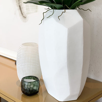 Eclectic Guaxs Cubistic tall opal white mouth-blown glass vase with faceted surface on a console table