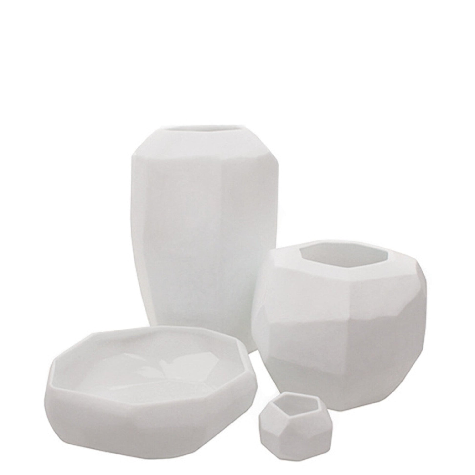Eclectic Guaxs Cubistic opal white glass vases in various sizes with faceted geometric surfaces and matte finish.