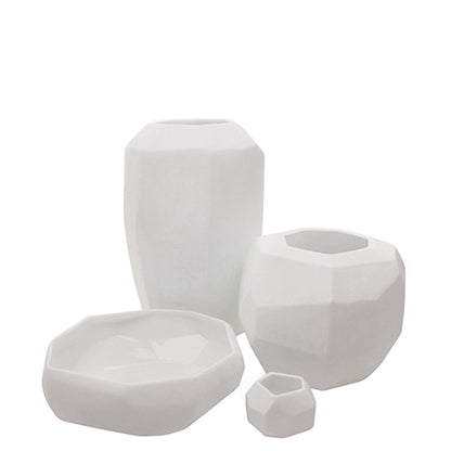 Eclectic Guaxs Cubistic opal white glass vases in various sizes with faceted geometric surfaces and matte finish.