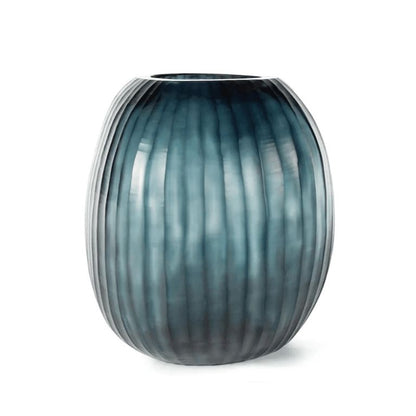 Eclectic Guaxs Patara round mouth-blown glass vase in ocean blue with a hand-cut pleated texture.