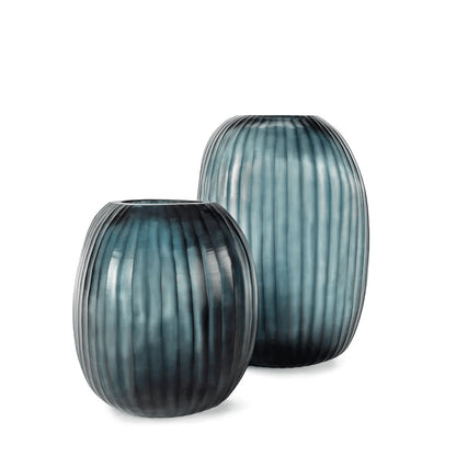 Eclectic Guaxs Patara mouth-blown glass vases in ocean blue with a hand-cut pleated texture and rounded silhouette.