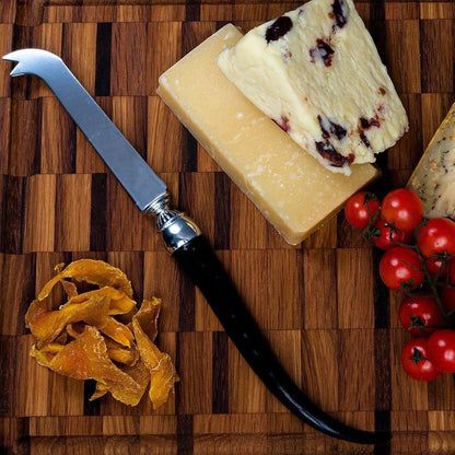 Eclectic Impondo Zulu cheese knife with a curved ebony resin handle, pewter detail, and stainless steel blade.