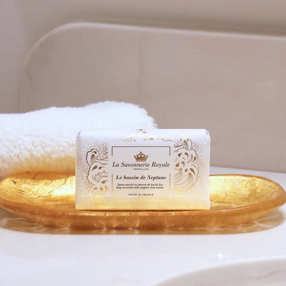 Eclectic La Savonnerie Royale Le Bassin de Neptune ivory soap bar with fleur-de-lys detail on a gold dish