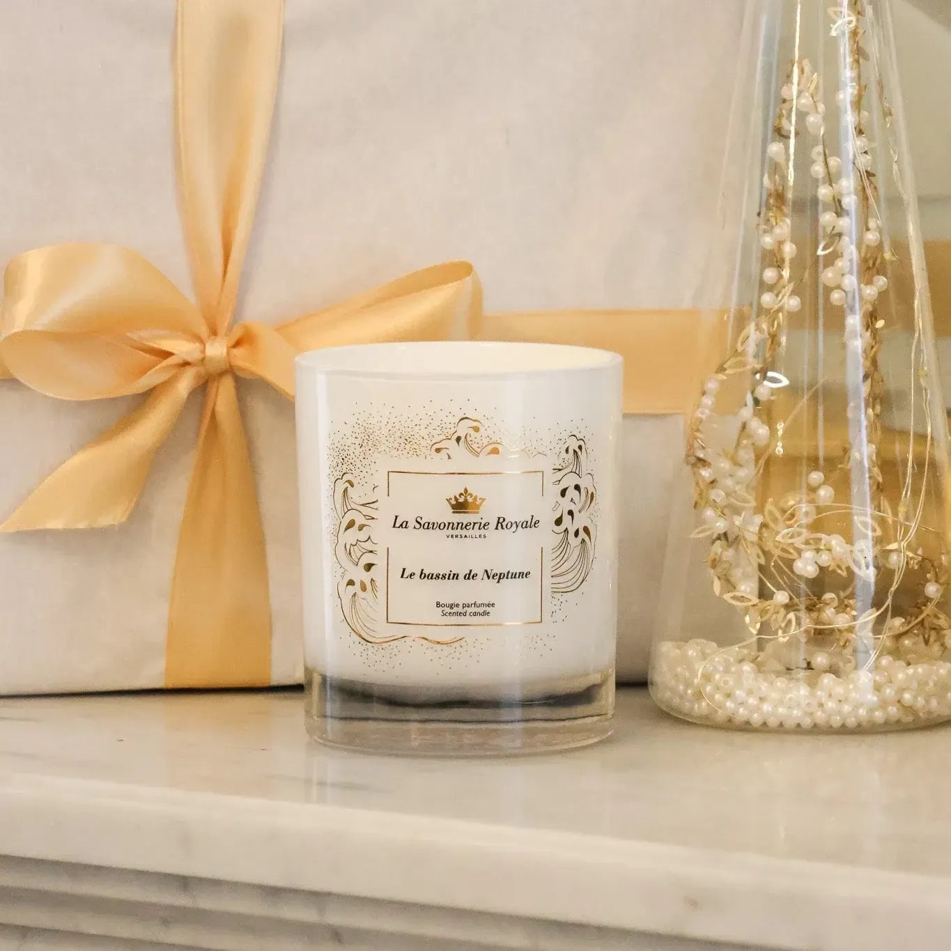 Eclectic La Savonnerie Royale Le Bassin de Neptune scented candle in an elegant white glass vessel with gold detailing.