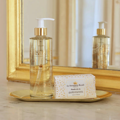 Eclectic La Savonnerie Royale Poudre de Riz soap bar and liquid soap dispenser on a gold tray in front of a mirror.