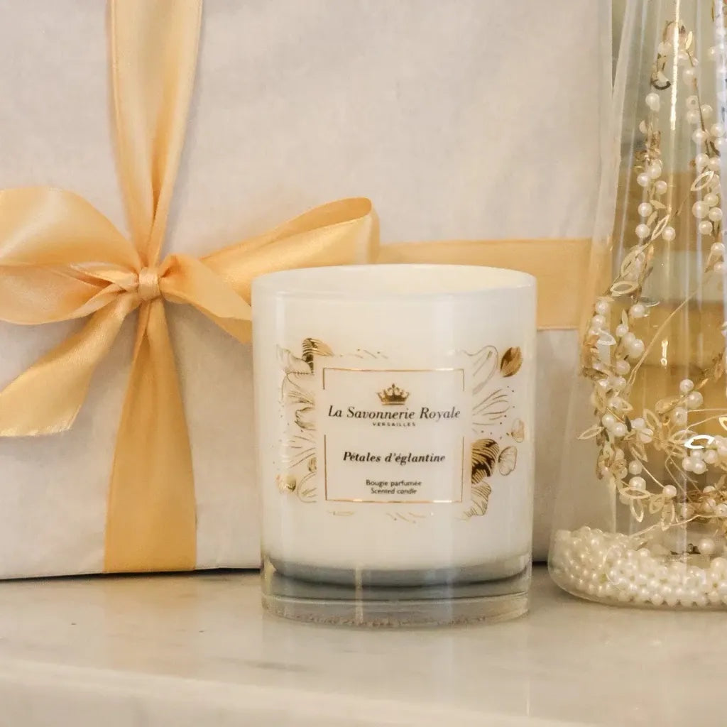 Eclectic La Savonnerie Royale Petales d'Eglantine rose scented candle in an ornate glass vessel with gold detailing.