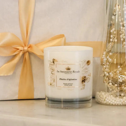 Eclectic La Savonnerie Royale Petales d'Eglantine rose scented candle in an ornate glass vessel with gold detailing.