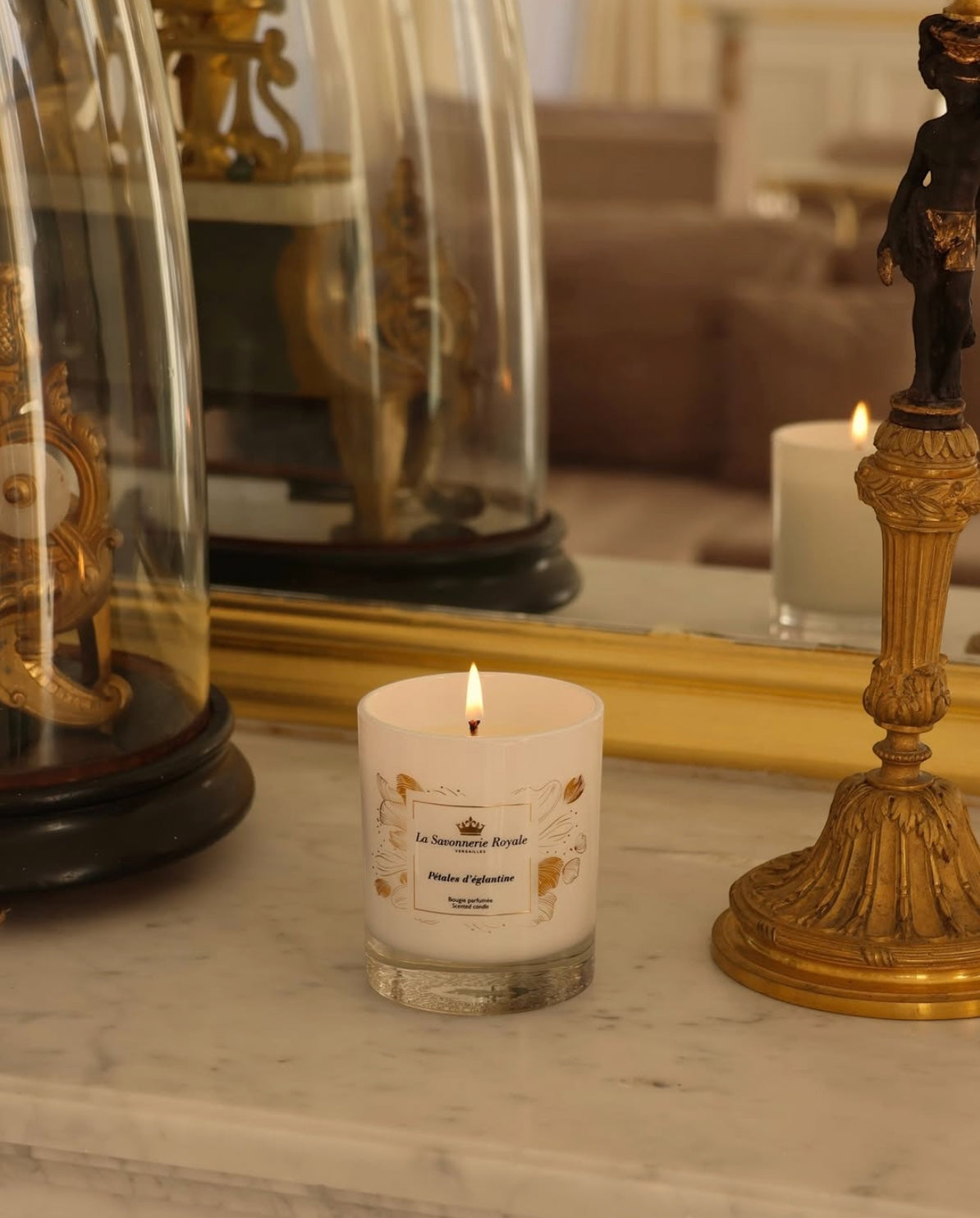 Eclectic La Savonnerie Royale Petales d'Eglantine rose scented candle in an ornate glass jar on a marble surface
