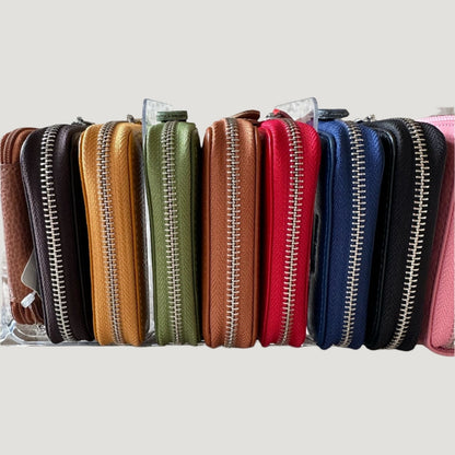 Eclectic Italian pebbled leather zip-around card holders in a variety of vibrant colours displayed in a row.