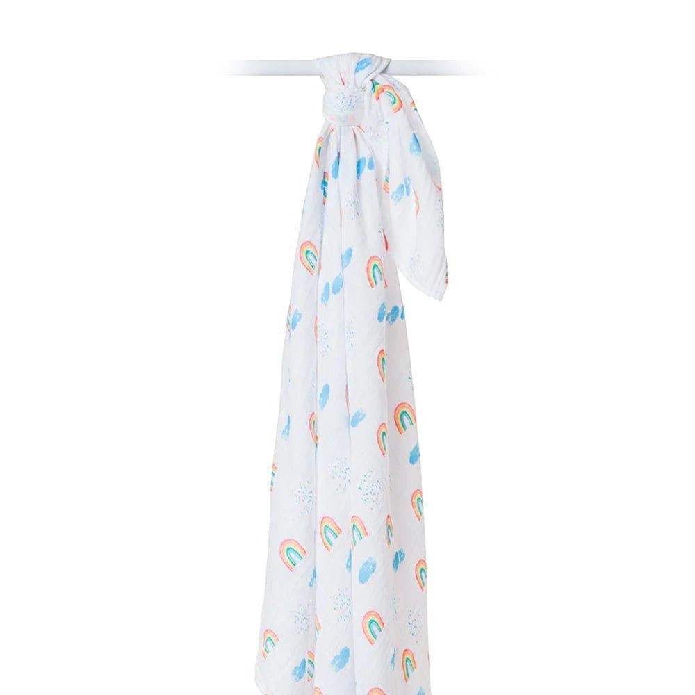 Eclectic Lulujo rainbow sky print cotton muslin swaddle blanket hanging against a white background