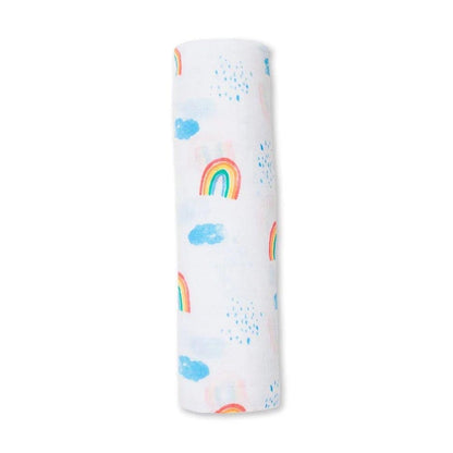 Eclectic Lulujo cotton muslin swaddle featuring a white background with a colourful rainbow and sky print.