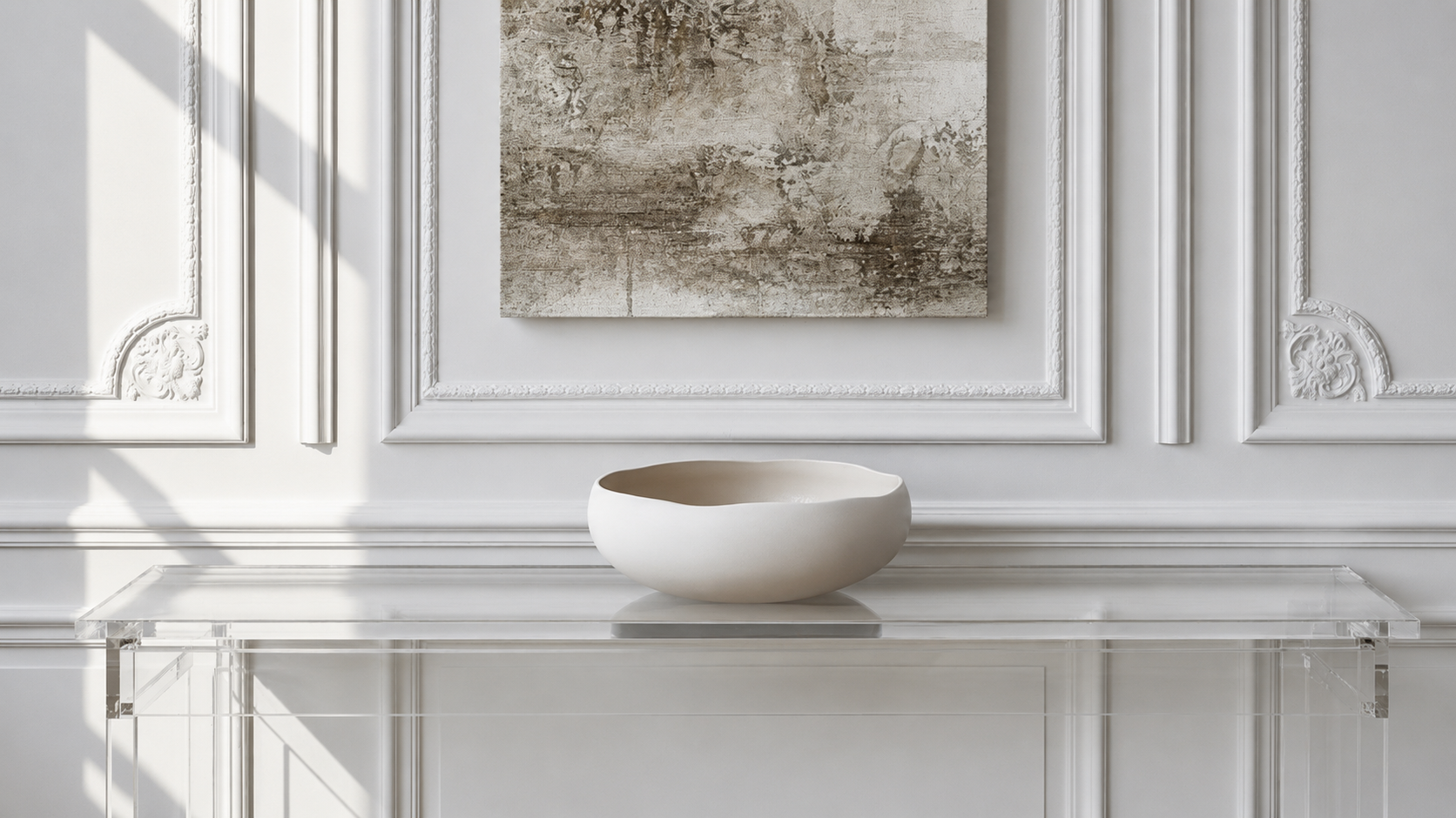 Elegant luxury home décor scene with a white ceramic bowl and abstract wall art.