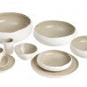 Eclectic Médard de Noblat Oslo stoneware collection featuring white and linen-toned coupe bowls and plates.