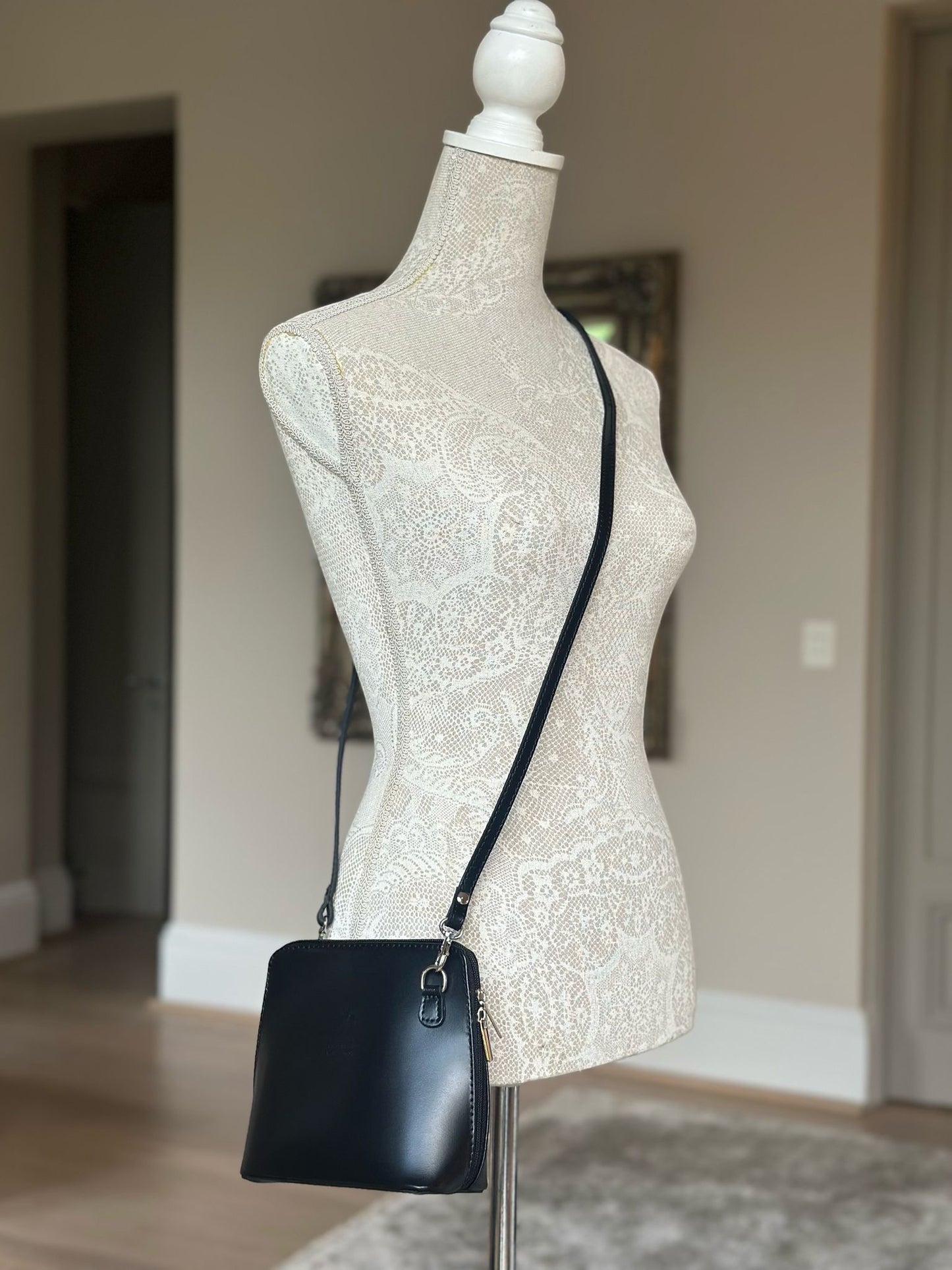 Eclectic Mini Milano black smooth leather crossbody bag with silver hardware on a mannequin