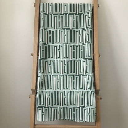 Eclectic mint green linen-look tablecloth featuring a modern geometric pattern draped over a wooden ladder.