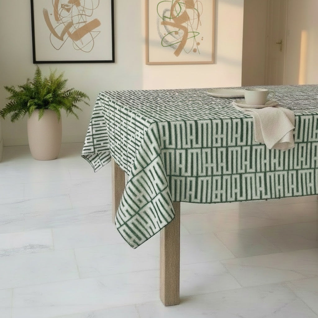 Eclectic mint green geometric linen-look tablecloth on a wooden dining table in a bright, modern room.
