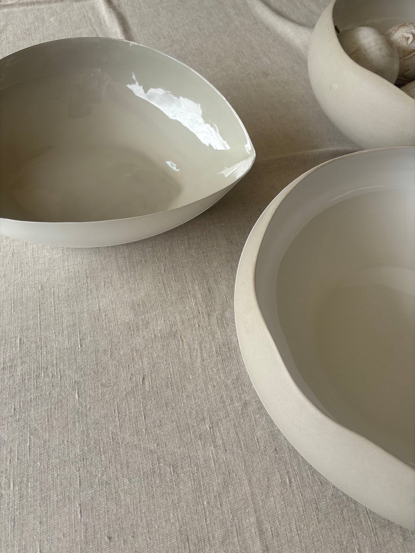Eclectic natural linen cotton blend tablecloth with a soft woven texture under minimalist ceramic bowls