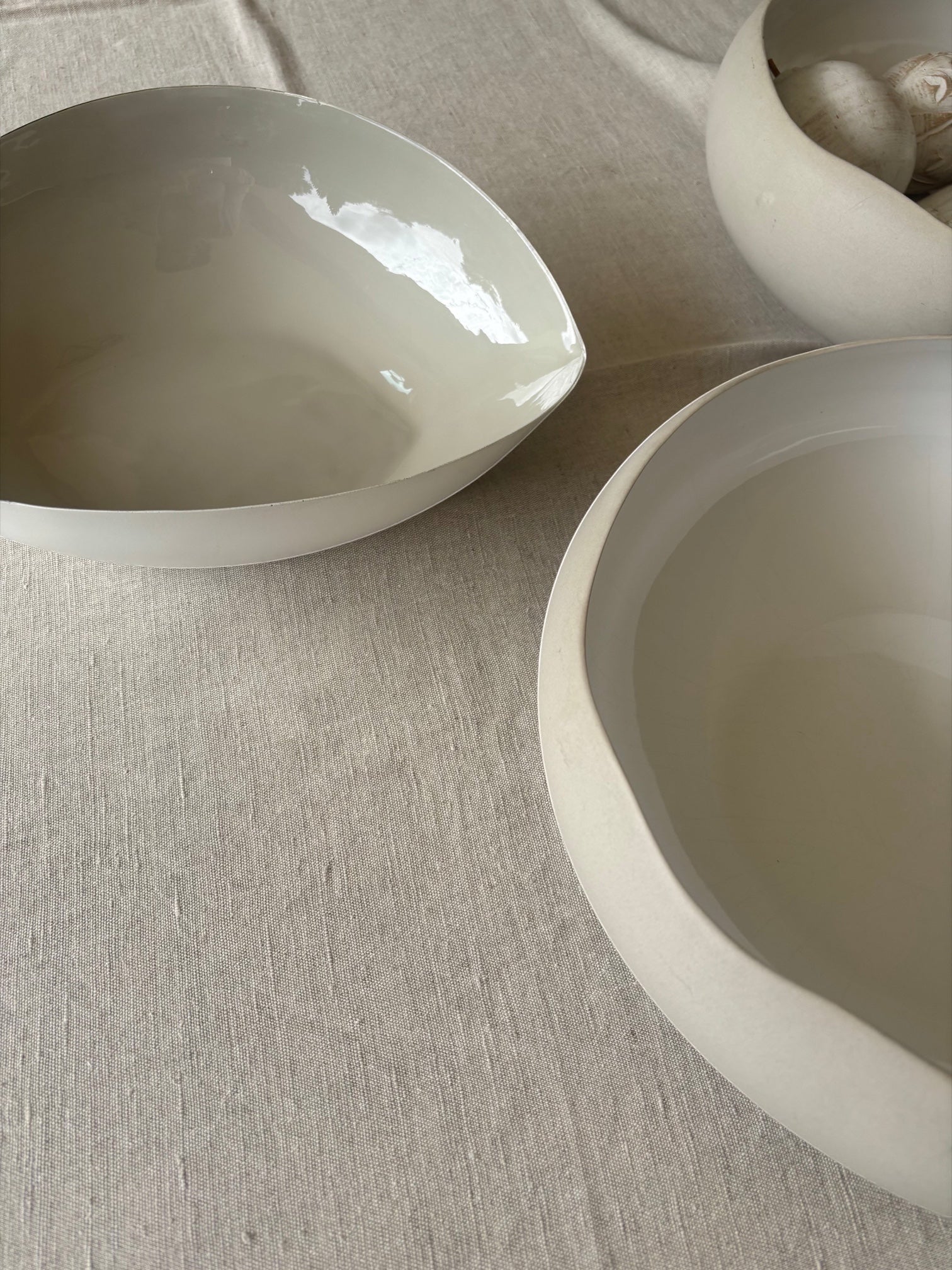 Eclectic natural linen cotton blend tablecloth with a soft woven texture under minimalist ceramic bowls