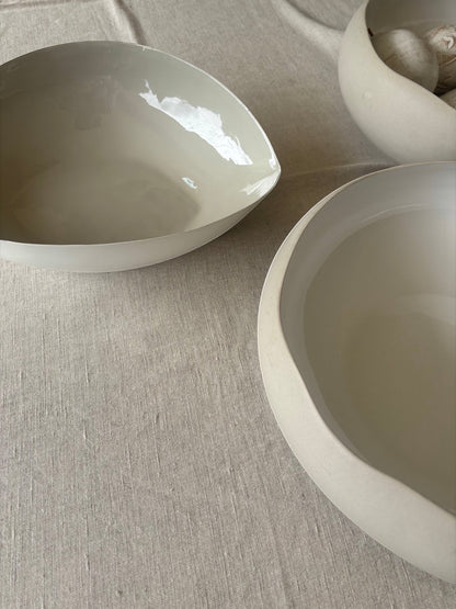 Eclectic natural linen cotton blend tablecloth with a soft woven texture under minimalist ceramic bowls