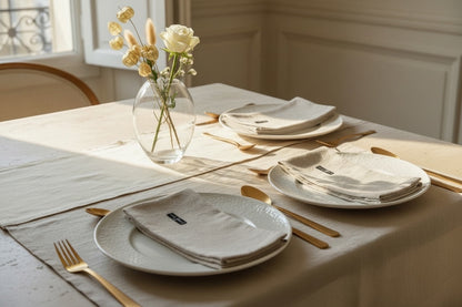 Eclectic set of four natural stonewashed linen napkins with a subtle scroll pattern on a refined dining table