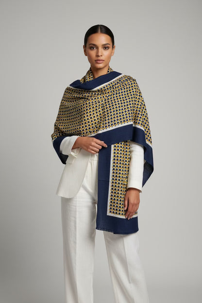 Eclectic navy and gold geometric print cashmere wool blend wrap worn over a white blazer